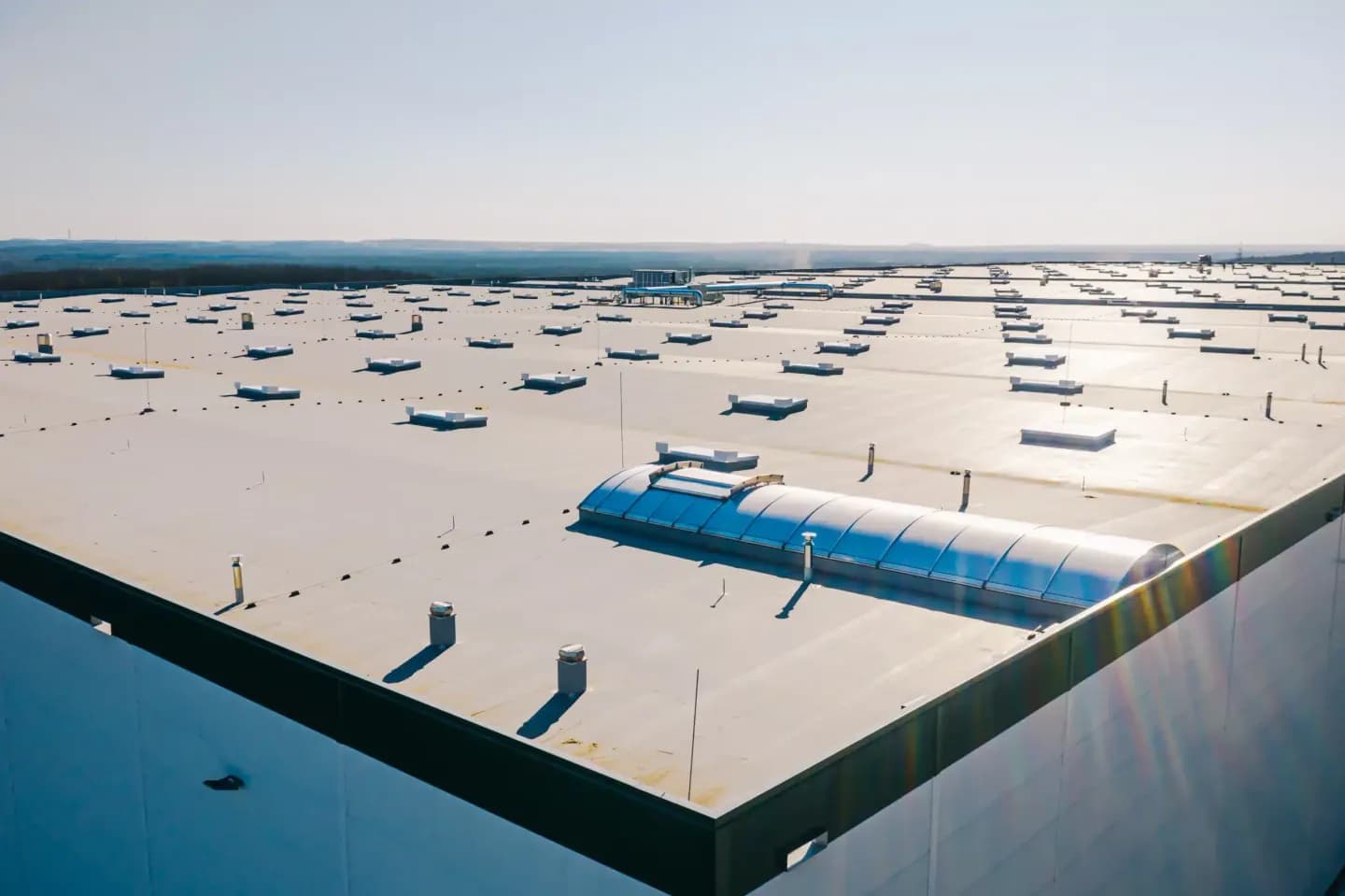 Large flat membrane roof on a commercial building