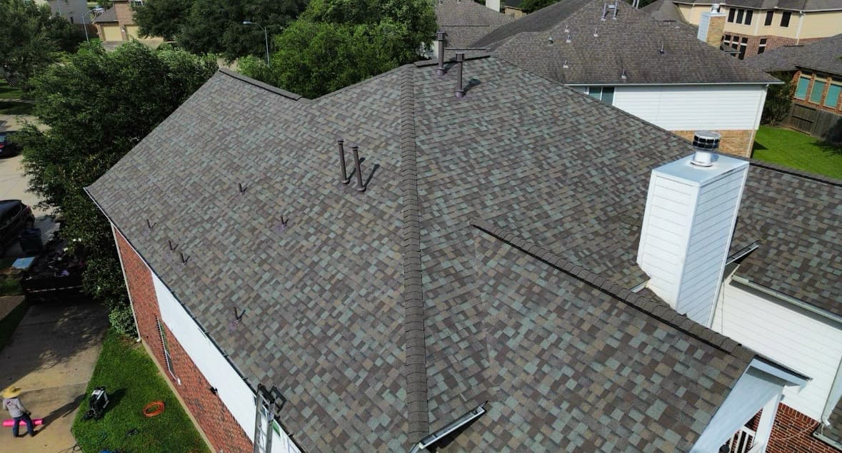 Completed residential shingle roof from a drone angle