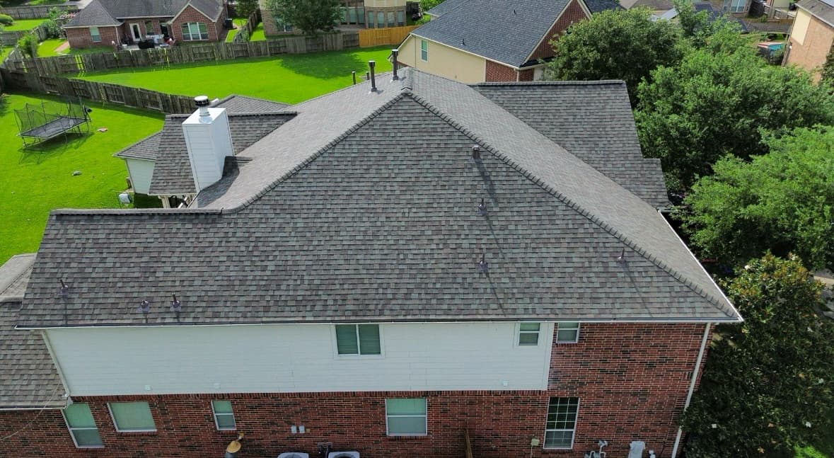 Completed residential shingle roof from the rear drone angle