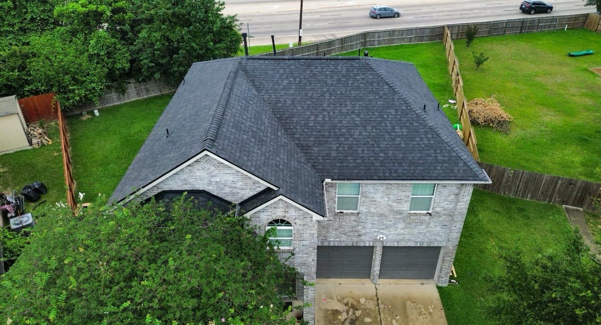 Completed dark shingle roof from the front of a home