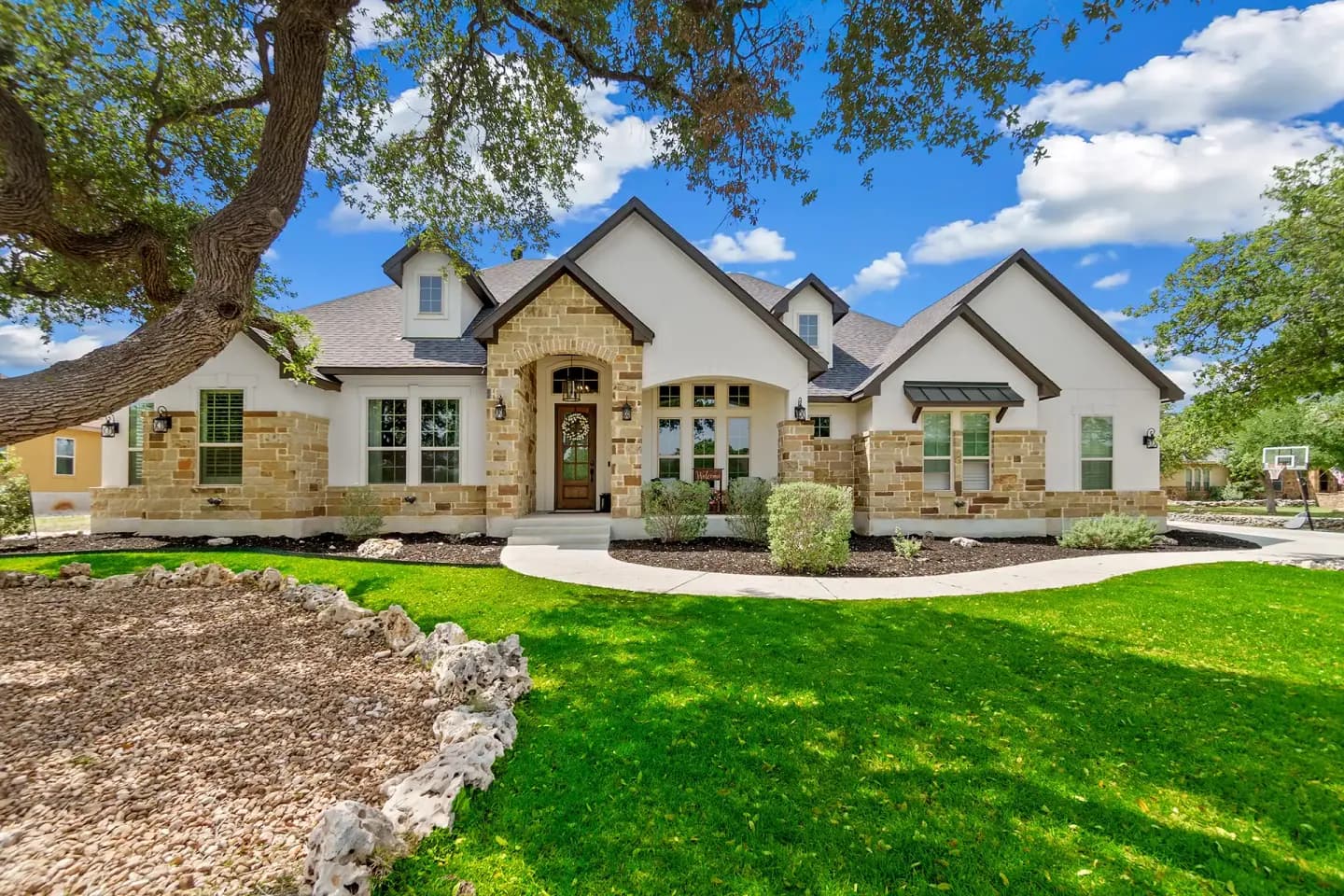 Stone Texas home with a new shingle roof